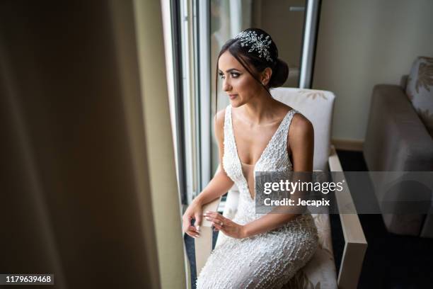 beautiful young bride posing in hotel apartment on wedding day - bridal makeup stock pictures, royalty-free photos & images