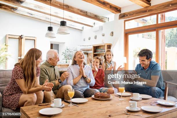 happy family celebrating birthday at home - older woman birthday stock pictures, royalty-free photos & images