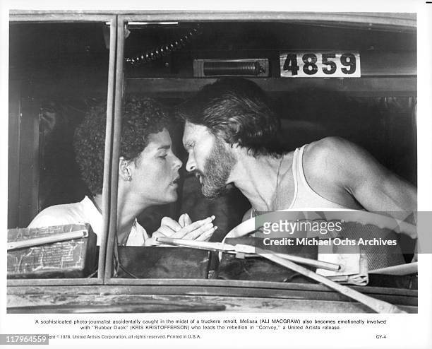 Ali MacGraw and Kris Kristofferson kiss in a scene from the film 'Convoy', 1978.