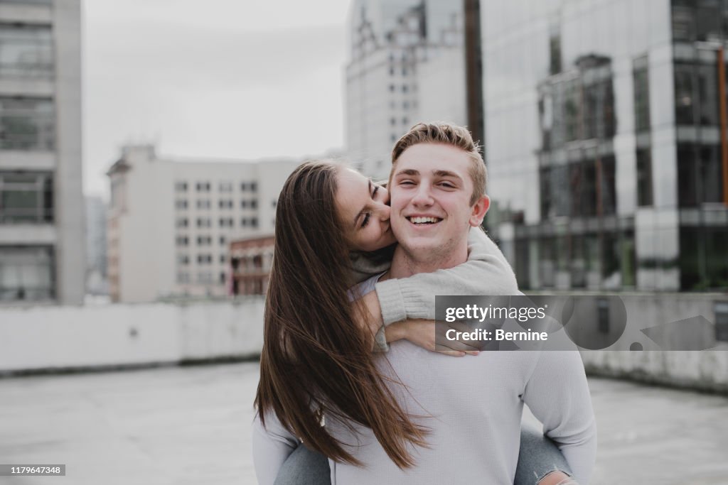 Adorable Young Couple Kissing on Cheek