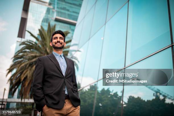 businessman in front of the business center - low angle view imagens e fotografias de stock