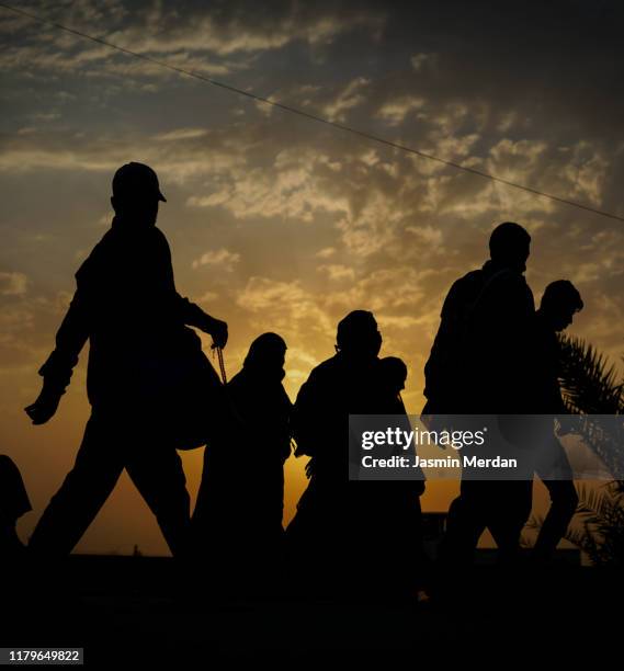 immigrants walking for hope in better future - refugee silhouette stock pictures, royalty-free photos & images