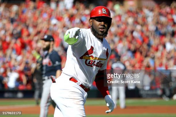 Marcell Ozuna of the St. Louis Cardinals celebrates after hitting a solo home run against the Atlanta Braves during the first inning in game four of...