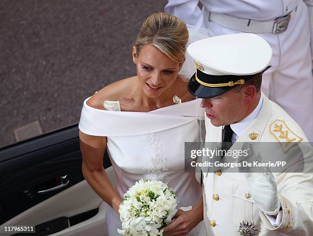 Princess Charlene of Monaco and Prince Albert II of Monaco leave the religious ceremony of the Royal Wedding of Prince Albert II of Monaco to...