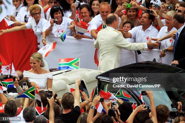 Prince Albert II of Monaco and Princess Charlene of Monaco depart from Sainte Devote church after their religious wedding ceremony at the Prince's...