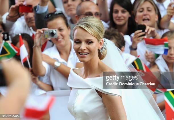 Princess Charlene of Monaco arrives at Sainte Devote church after the religious wedding ceremony to Prince Albert II of Monaco after the religious...