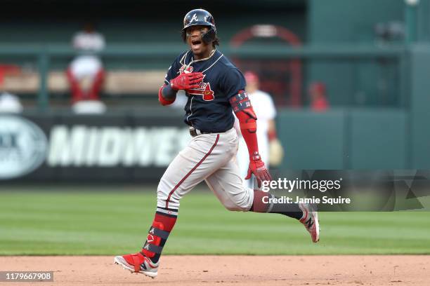 Ronald Acuna Jr. #13 of the Atlanta Braves celebrates after hitting a double against the St. Louis Cardinals during the ninth inning in game four of...