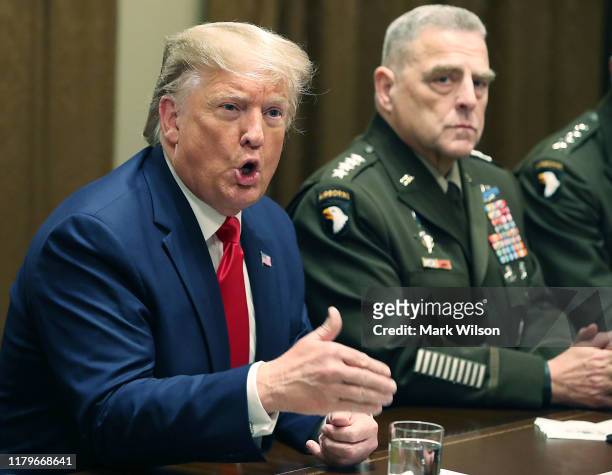 President Donald Trump speaks as Joint Chiefs of Staff Chairman, Army General Mark Milley looks on after a briefing from senior military leaders in...