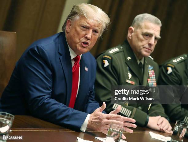 President Donald Trump speaks as Joint Chiefs of Staff Chairman, Army General Mark Milley looks on after a briefing from senior military leaders in...