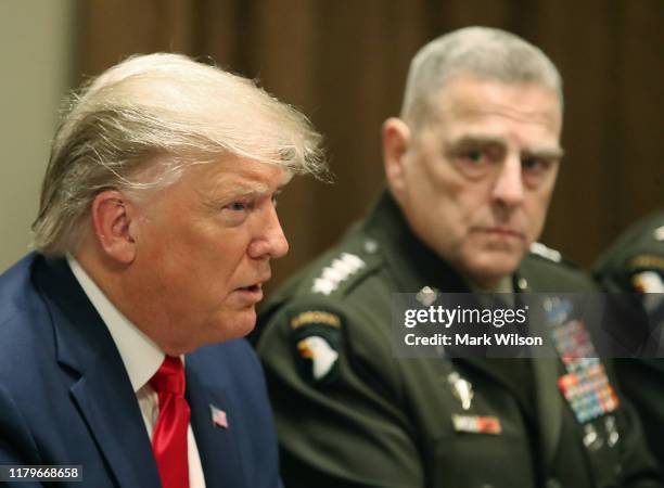 President Donald Trump speaks as Joint Chiefs of Staff Chairman, Army Gen. Mark Milley looks on after getting a briefing from senior military leaders...