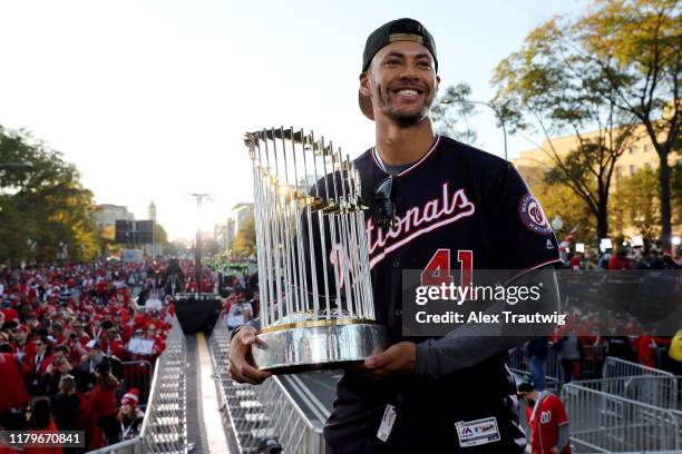 Joe Ross of the Washington Nationals poses for a photo with the Commissioner's Trophy during the 2019 World Series victory parade on Saturday,...