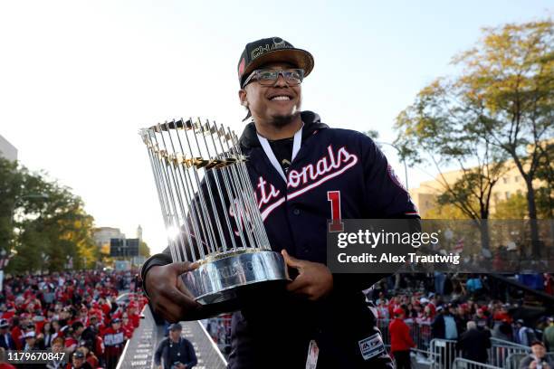 Wilmer Difo of the Washington Nationals poses for a photo with the Commissioner's Trophy during the 2019 World Series victory parade on Saturday,...