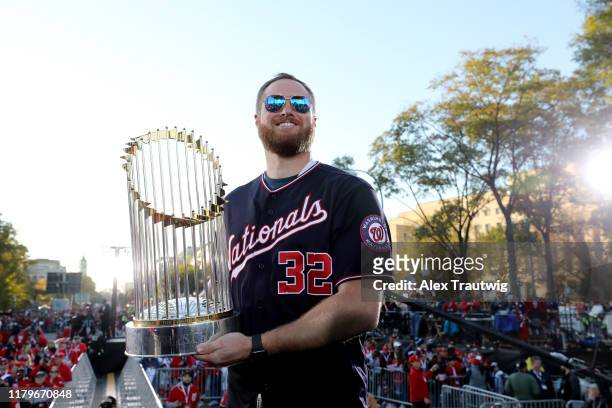 Aaron Barrett of the Washington Nationals poses for a photo with the Commissioner's Trophy during the 2019 World Series victory parade on Saturday,...