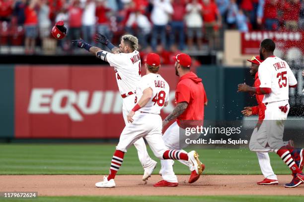 Yadier Molina of the St. Louis Cardinals hits a walk-off sacrifice fly to give his team the 5-4 win over the Atlanta Braves in game four of the...