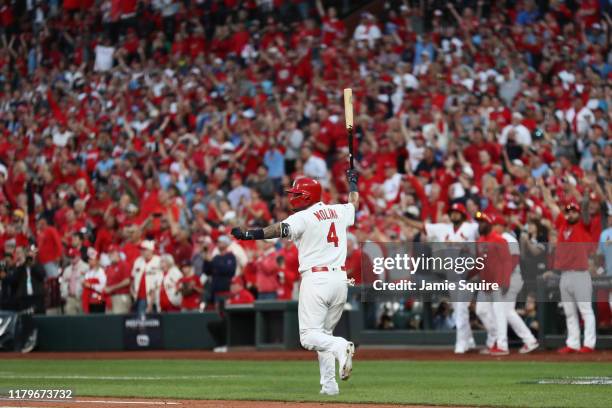 Yadier Molina of the St. Louis Cardinals celebrates as he hits a walk-off sacrifice fly to give his team the 5-4 win over the Atlanta Braves in game...