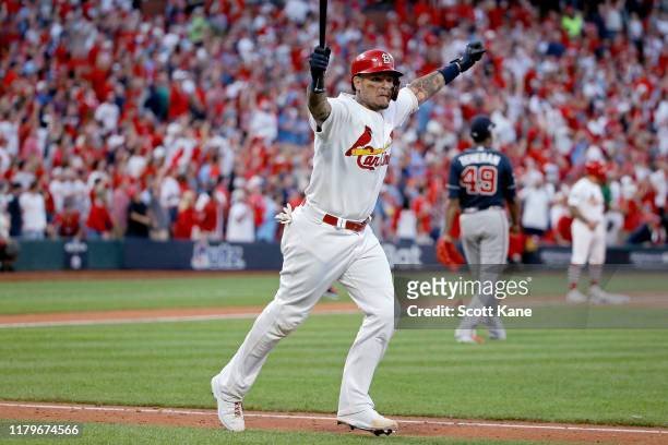 Yadier Molina of the St. Louis Cardinals celebrates as he hits a walk-off sacrifice fly to give his team the 5-4 win over the Atlanta Braves in game...