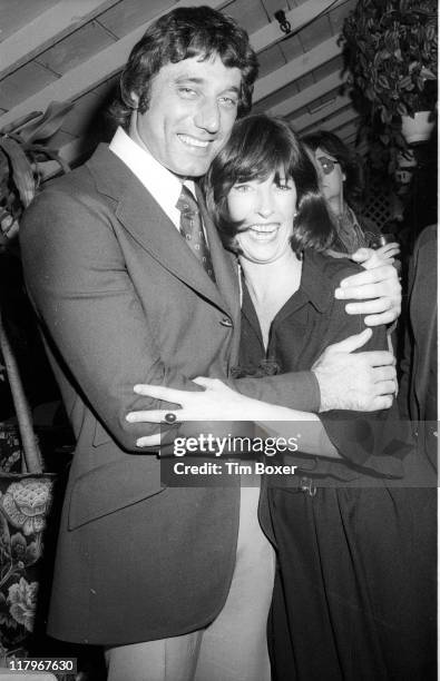 At a party for Faberge's 'Babe' perfume, American football player Joe Namath hugs Faberge press agent Valerie Jennings at Cecil's, New York, New...