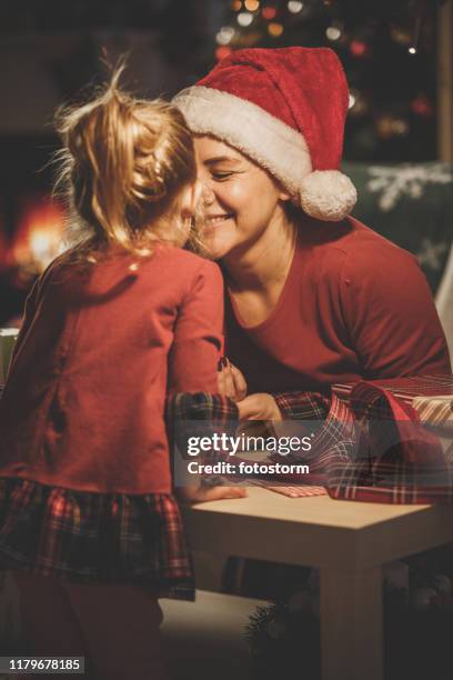 mother and daughter exchanging moments of affection together - hug christmas stock pictures, royalty-free photos & images
