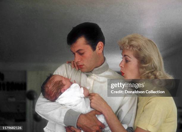 Actors Janet Leigh and Tony Curtis pose for a portrait with their daughter Kelly Curtis at home on August 4, 1956 in Los Angeles, California.