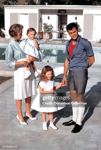 Actors Janet Leigh and Tony Curtis play with their daughters daughters Jamie Lee Curtis and Kelly Curtis by the pool at home on April 4, 1960 in Los...