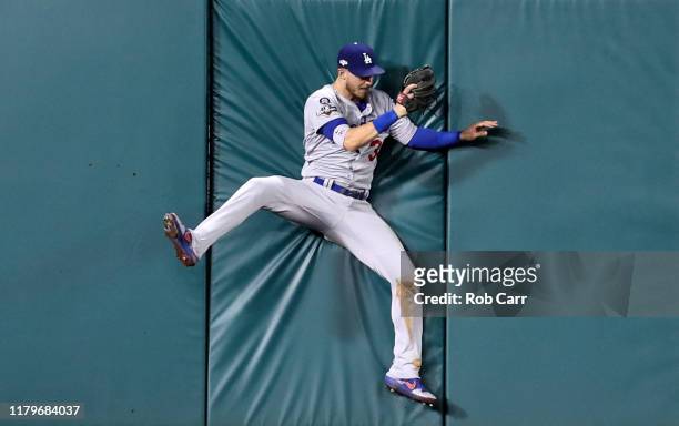 Cody Bellinger of the Los Angeles Dodgers makes the catch on a sacrifice fly hit by Anthony Rendon of the Washington Nationals to drive in a run in...
