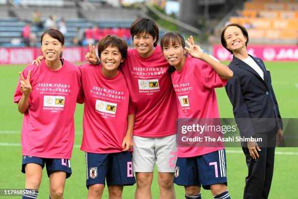 Hina Sugita, Mana Iwabuchi, Rei Takenaka, Emi Nakajima and head coach Asako Takakura of Japan pose for photographs after their 4-0 victory in the...