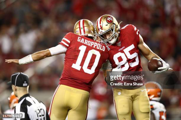 George Kittle is congratulated by Jimmy Garoppolo of the San Francisco 49ers after Garoppolo threw a touchdown pass to Kittle against the Cleveland...
