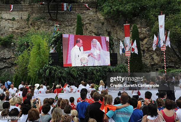 Crowds watch the big screen of the the religious wedding ceremony of Prince Albert II of Monaco and Princess Charlene of Monaco at the Sainte Devote...