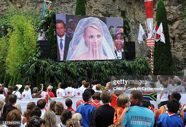 Crowds watch the big screen of the the religious wedding ceremony of Prince Albert II of Monaco and Princess Charlene of Monaco at the Sainte Devote...