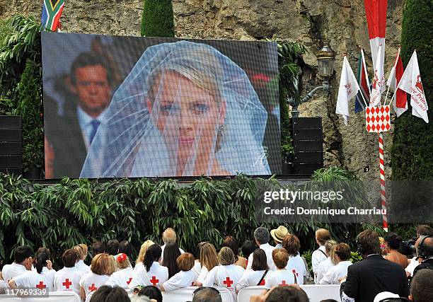 Crowds watch the big screen of the religious wedding ceremony of Prince Albert II of Monaco and Princess Charlene of Monaco at the Sainte Devote...