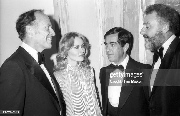 At his home for the release party for the film 'The Next Man' , MGM chairman Louis Bo Polk poses with the film's star, American actress Cornelia...