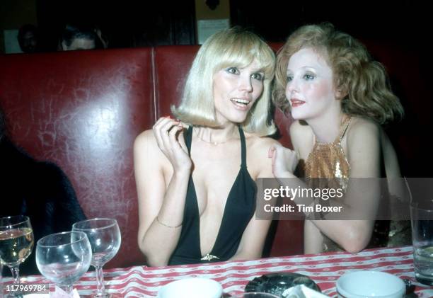 French singer and actress Amanda Lear and South African actress and singer Genevieve Waite sit together at the premiere party for the Broadway show...