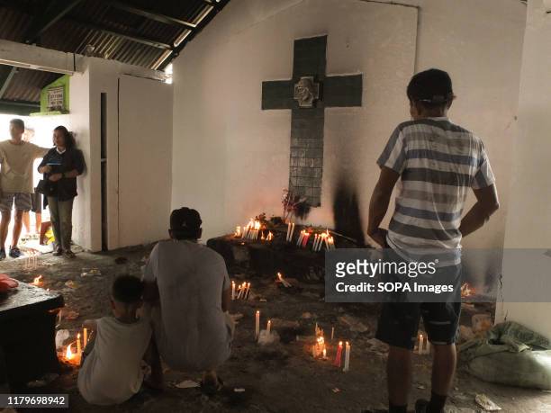 People light candles while praying for the souls of their deceased ones. Filipinos flock to cemeteries around the country to visit departed relatives...