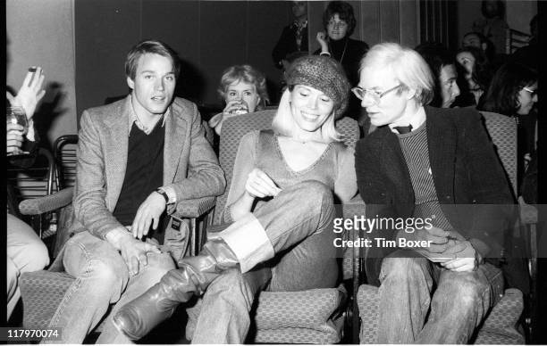 American Pop artist Andy Warhol speaks to French singer and actress Andrea Lear at the premiere of 'Shampoo' at the Columbia Pictures Screening Room,...