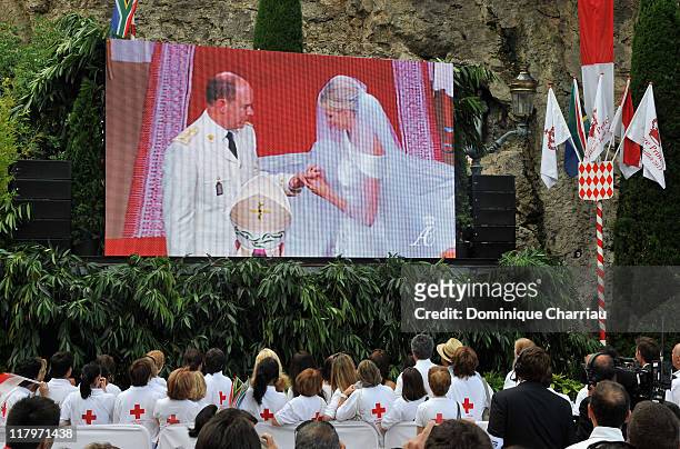 Crowds watch the big screen of the religious wedding ceremony of Prince Albert II of Monaco and Princess Charlene of Monaco at the Sainte Devote...