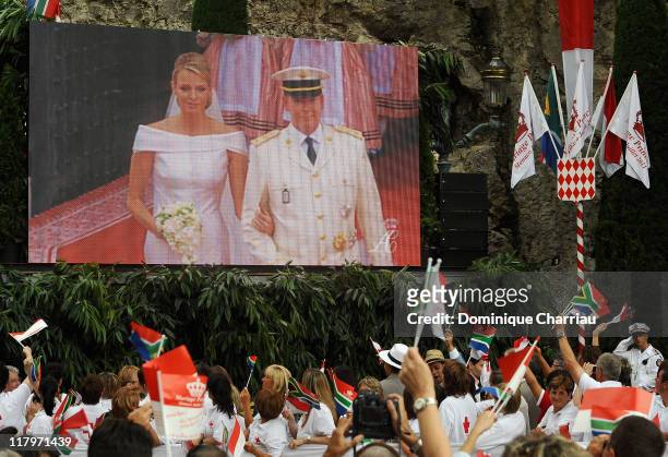 Crowds watch the big screen of the religious wedding ceremony of Prince Albert II of Monaco and Princess Charlene of Monaco at the Sainte Devote...