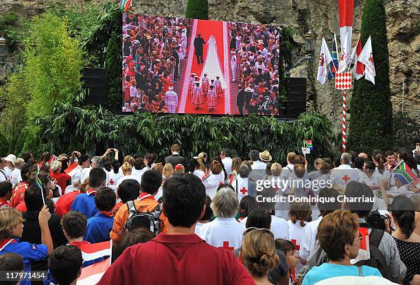 Crowds watch the big screen of the religious wedding ceremony of Prince Albert II of Monaco and Princess Charlene of Monaco at the Sainte Devote...