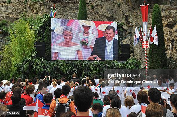 Crowds watch the big screen of the religious wedding ceremony of Prince Albert II of Monaco and Princess Charlene of Monaco at the Sainte Devote...