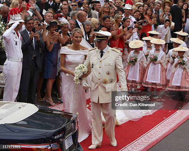 Princess Charlene of Monaco and Prince Albert II of Monaco make their journey to Sainte Devote church after their religious wedding ceremony at the...