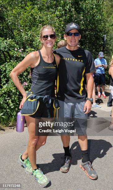 Anna Hansen and Lance Armstrong greet people at the base of Ute Trail after Armstrong tweets his intent to climb the 2.2 mile trail during the Aspen...