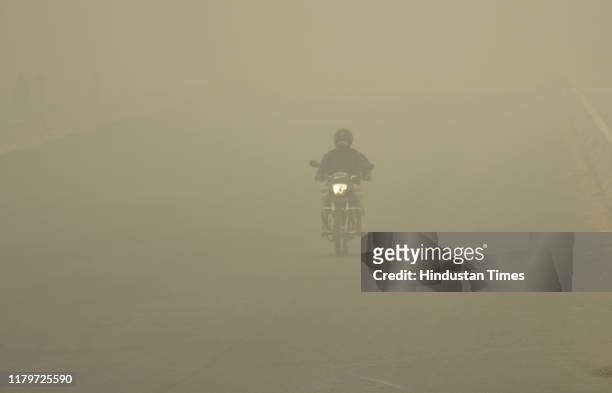 Vehicles ply on road amid heavy smog, at NH 9 road, on November 3, 2019 in Ghaziabad, India. The air quality index hit 473 at 9 am, according to...