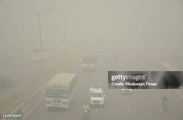 Vehicles ply on road amid heavy smog, at NH 9 road, on November 3, 2019 in Ghaziabad, India. The air quality index hit 473 at 9 am, according to...