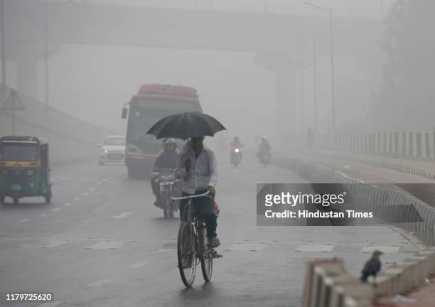 Vehicles ply on road amid heavy smog, at NH-9, near IP Extension, on November 3, 2019 in New Delhi, India. The air quality index hit 473 at 9 am,...