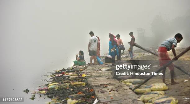 Workers seen cleaning after Chatth Puja, near a bank of Yamuna river, ITO, Vikas Marg, on November 3, 2019 in New Delhi, India. The air quality index...