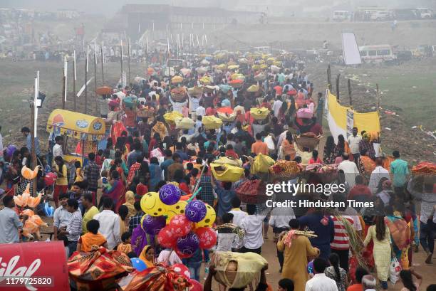 Devotees returning after performing Chhath Puja rituals, at Digha Ghat, on November 3, 2019 in Patna, India. Thousands of devotees celebrating Chhath...