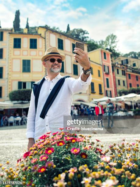 tourist in portofino making selfie - portofino stock pictures, royalty-free photos & images