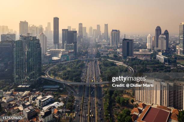 aerial view of the semanggi fly over in jakarta downtown district at sunrise in indonesia capital city - ジャカルタ ストックフォトと画像