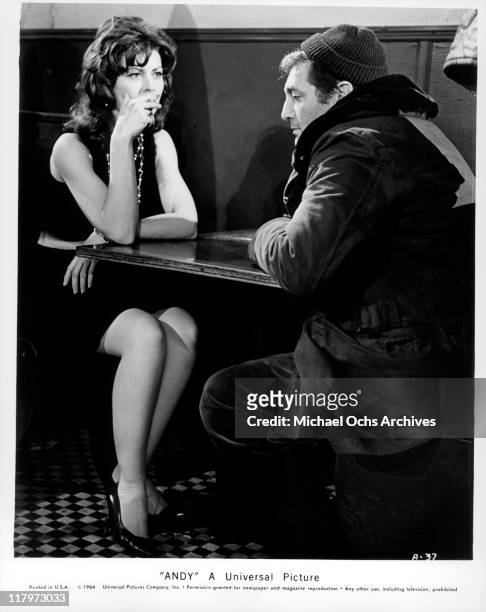 Ann Wedgeworth smoking a cigarette while looking at Norman Alden in a scene from the film 'Andy', 1965.