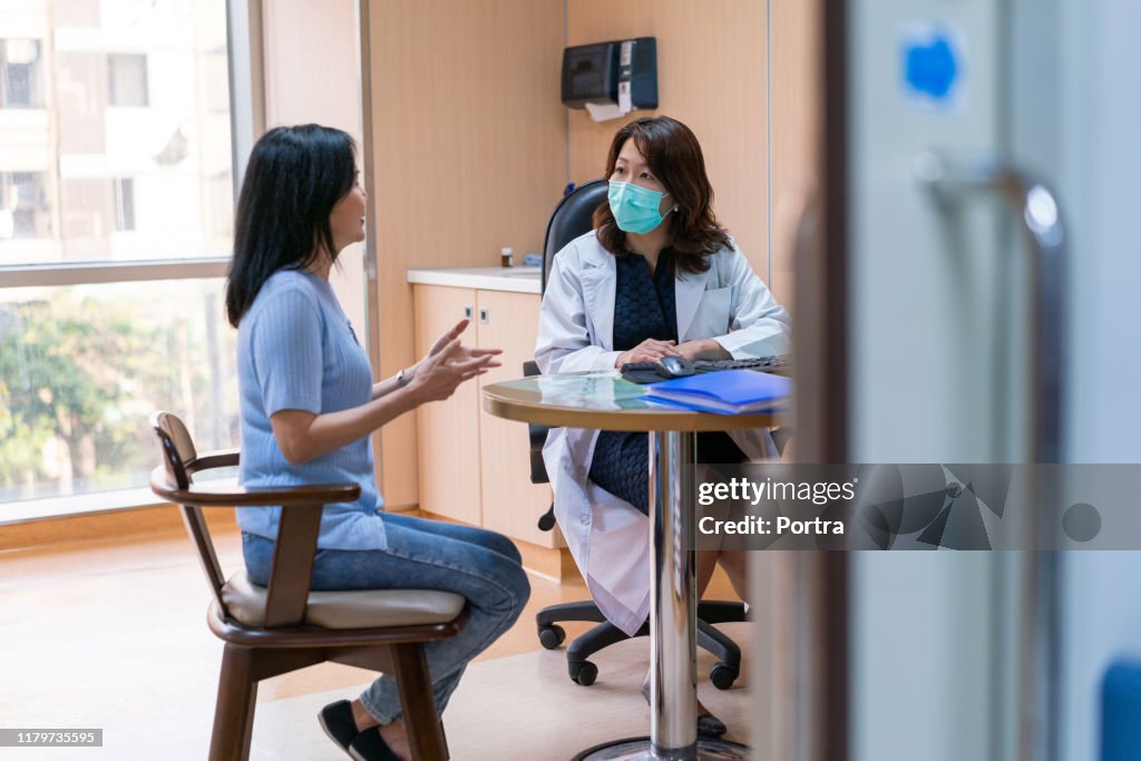 Patient explaining female doctor in medical clinic