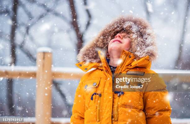 boy enjoying winter - kid looking down stock pictures, royalty-free photos & images